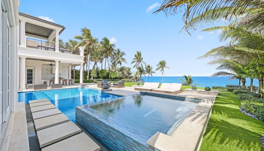 Ocean-to-Intracoastal estate with pool terrace and ocean beyond