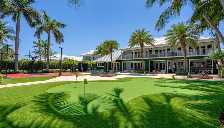 Key West-style estate seen across the lawn and putting green
