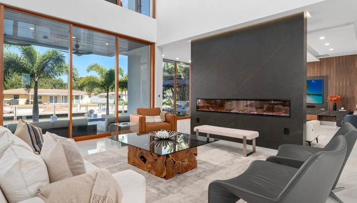 Living room with linear fireplace and water views