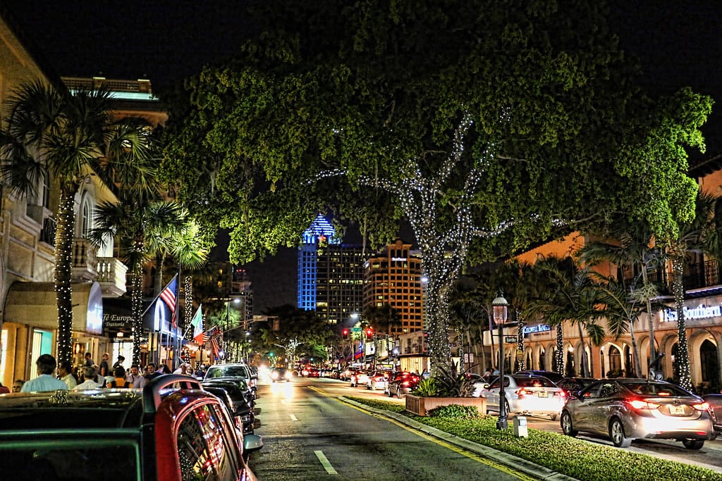 Las Olas Boulevard in the evening, its trees strung with lights above restaurants and shopfronts